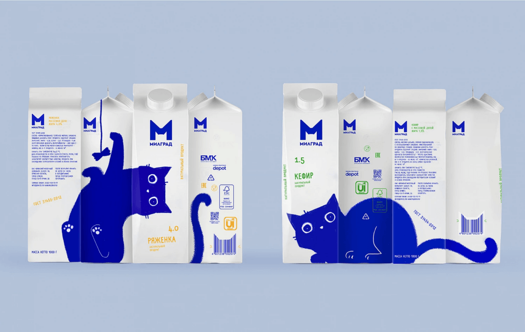 Белая упаковка молока с иллюстрацией котенка